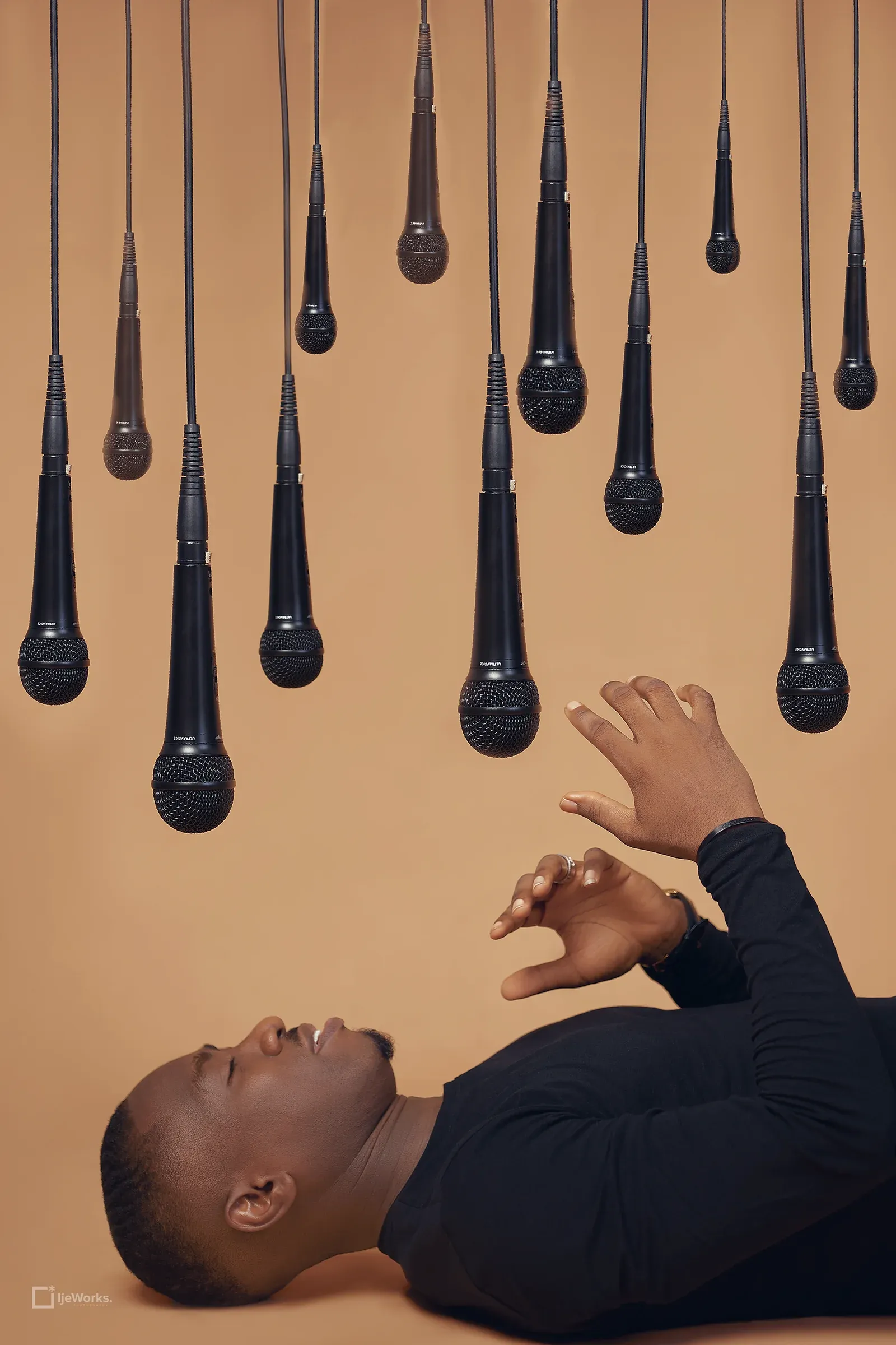 David Nkennor beneath a cluster of suspended microphones.